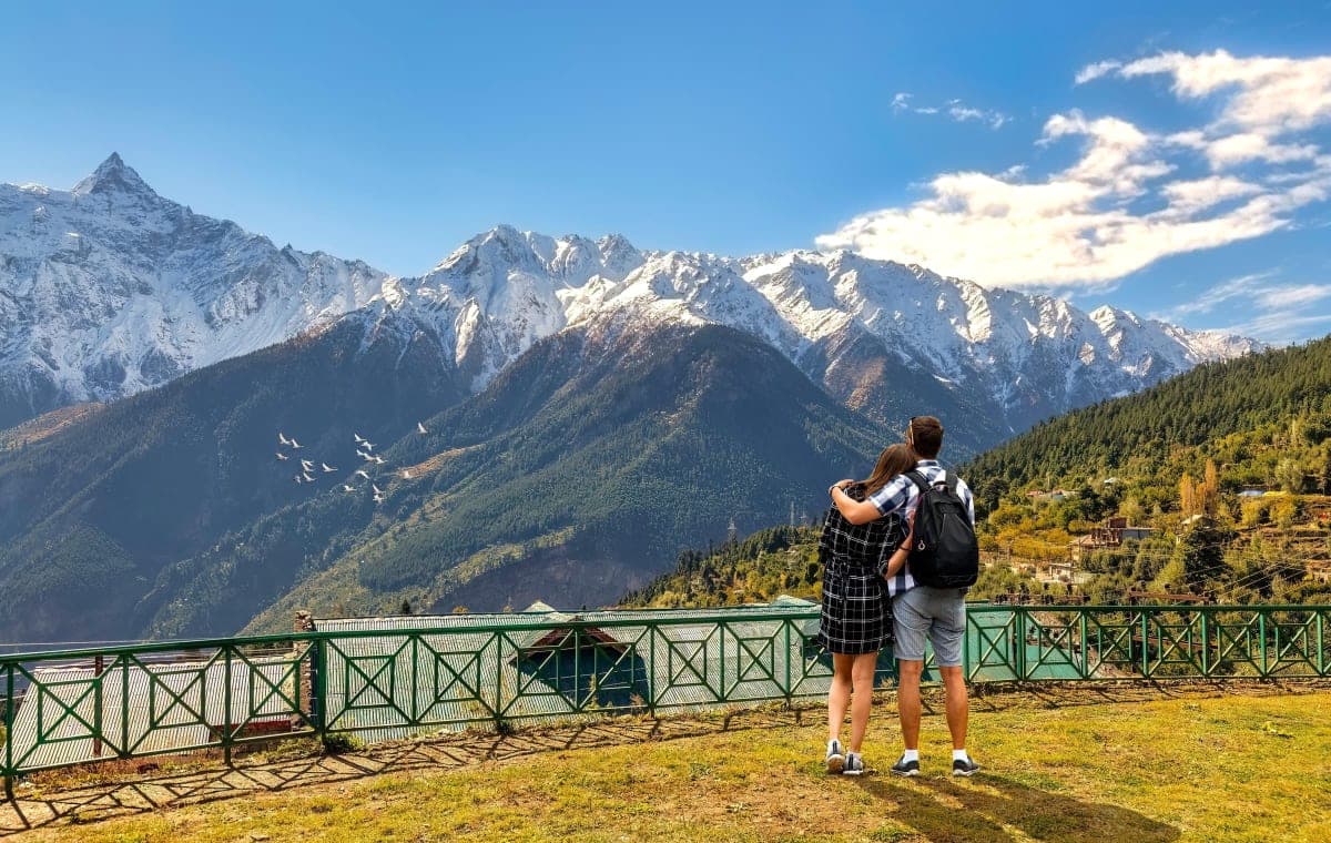 Couple overlooking Kullu Valley at sunset